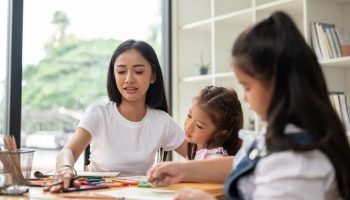 beautiful-asian-female-teacher-babysitter-is-teaching-art-young-kids-home_67155-37793